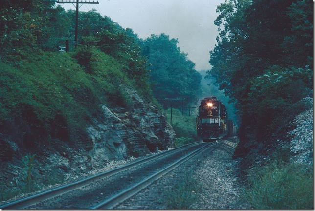Southern Ry 7060-7044-BN 6246 with w/b freight #120 grinds up Duncan hill at Edwardsville IN. He is doubling the hill from New Albany and has 37 cars. Train originated at Youngtown Yard (K&IT) in Louisville. It is a steep climb out of the Ohio River valley. 09-03-1981.